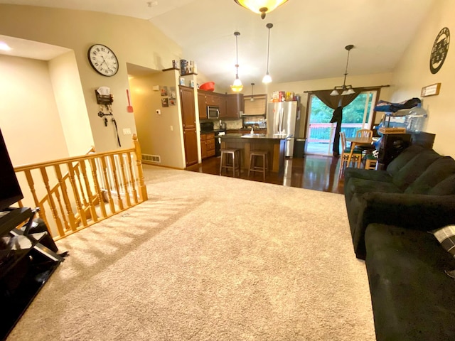 living room featuring vaulted ceiling and dark colored carpet