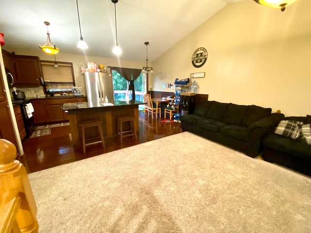 living room featuring vaulted ceiling and dark hardwood / wood-style flooring