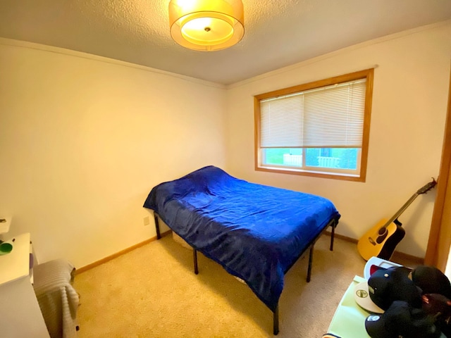 carpeted bedroom with a textured ceiling and ornamental molding