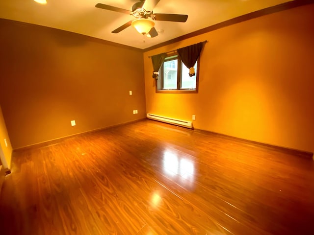 unfurnished room featuring ornamental molding, hardwood / wood-style flooring, baseboard heating, and ceiling fan