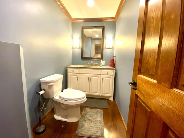 bathroom featuring ornamental molding, vanity, toilet, and hardwood / wood-style floors