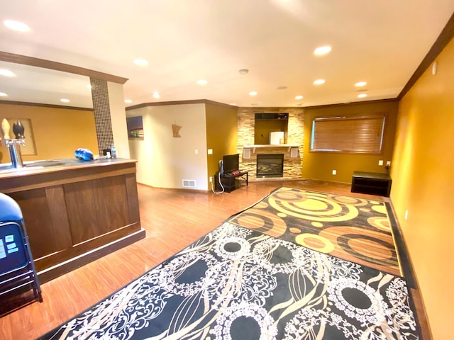 interior space featuring bar and a stone fireplace