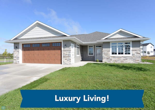 view of front of property with a garage, concrete driveway, a front lawn, and stone siding
