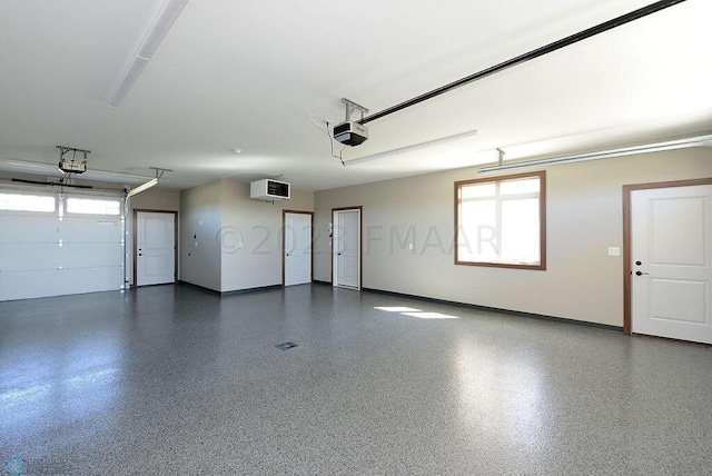 garage with baseboards and a garage door opener