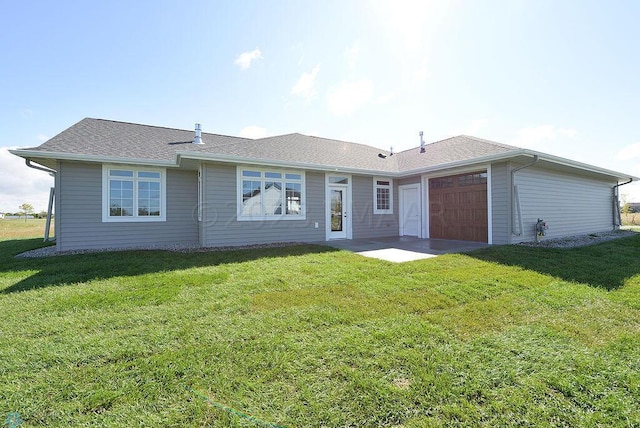 single story home featuring a garage and a front yard