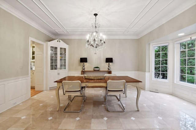 dining space featuring crown molding and a notable chandelier