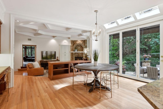 dining room featuring a fireplace, plenty of natural light, and light hardwood / wood-style flooring