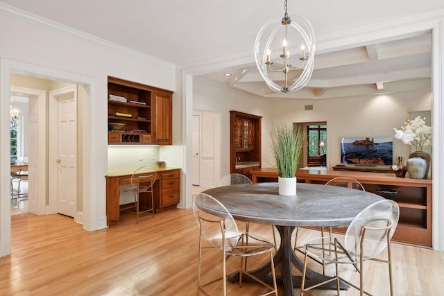 dining space featuring beamed ceiling, light wood-type flooring, an inviting chandelier, and ornamental molding