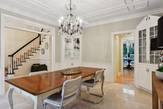 dining room featuring an inviting chandelier and crown molding