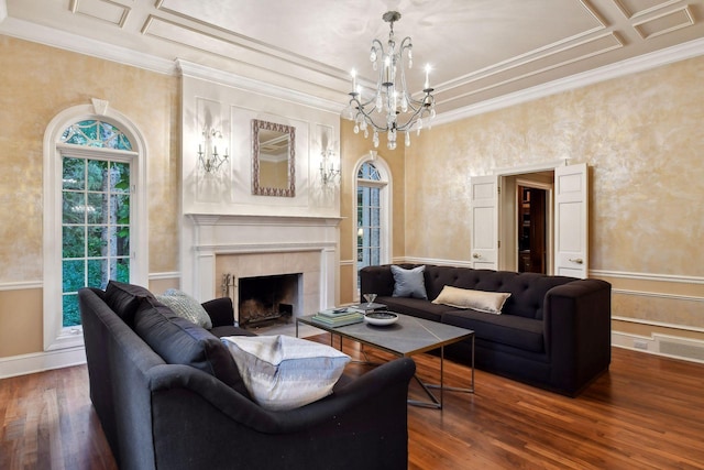 living room with a tile fireplace, an inviting chandelier, coffered ceiling, ornamental molding, and dark hardwood / wood-style flooring