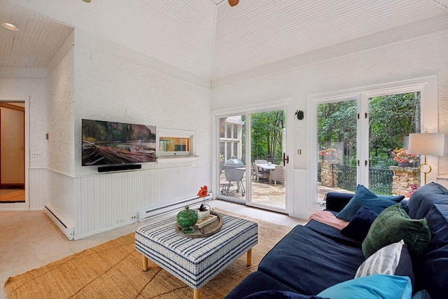 living room with a healthy amount of sunlight, light tile patterned flooring, a towering ceiling, and baseboard heating