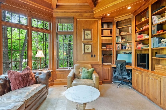 interior space featuring beam ceiling, wood walls, plenty of natural light, and light carpet