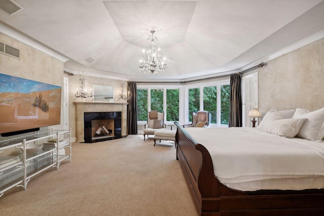 bedroom with a fireplace, light carpet, a tray ceiling, and an inviting chandelier