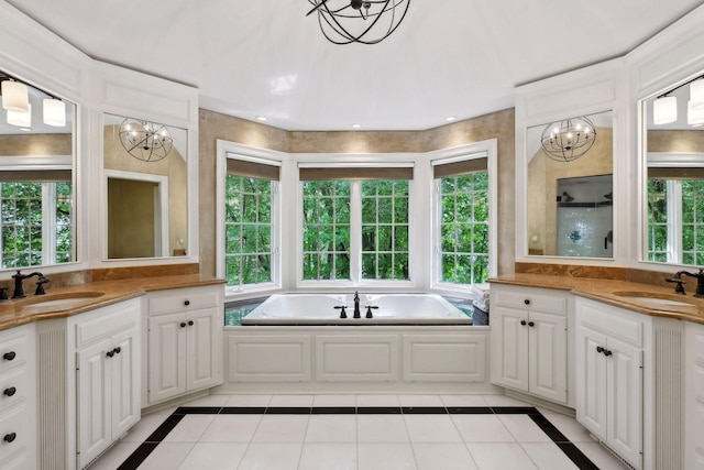 bathroom featuring tile patterned floors, a notable chandelier, and vanity