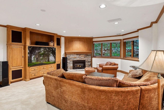 living room featuring a stone fireplace, light colored carpet, and crown molding