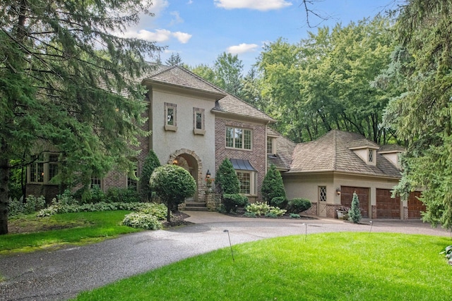 view of front of home featuring a garage and a front lawn