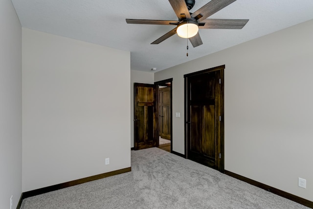 unfurnished bedroom featuring ceiling fan and carpet flooring