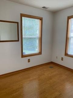 spare room with hardwood / wood-style flooring