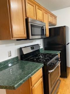 kitchen featuring stainless steel appliances and light hardwood / wood-style flooring