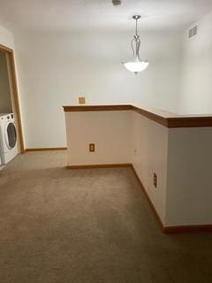 spare room featuring carpet flooring and washer / clothes dryer