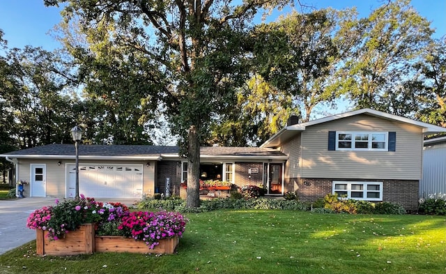 split level home featuring a front lawn and a garage