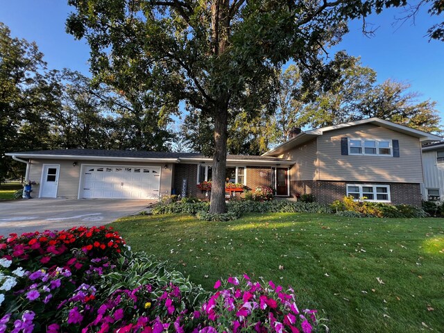 tri-level home featuring a garage and a front yard