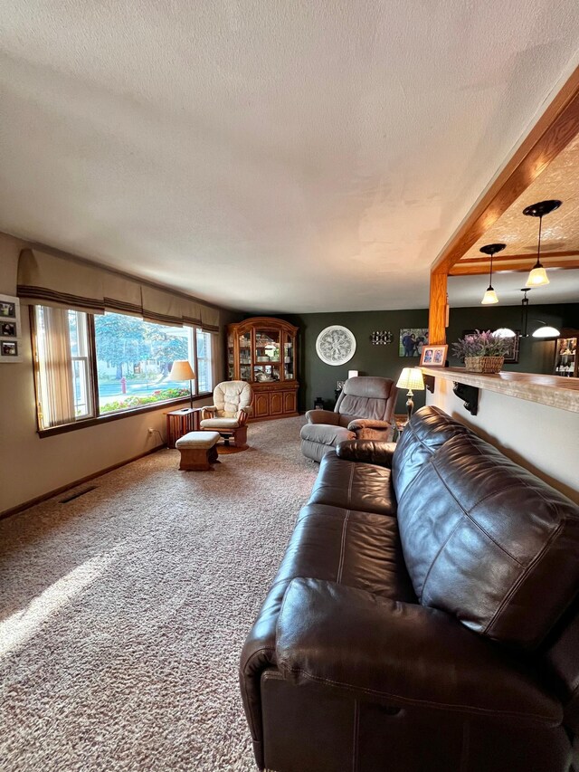 carpeted living room featuring a textured ceiling