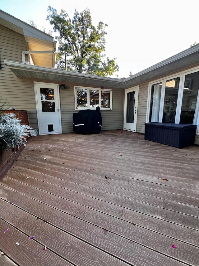 wooden deck with a grill