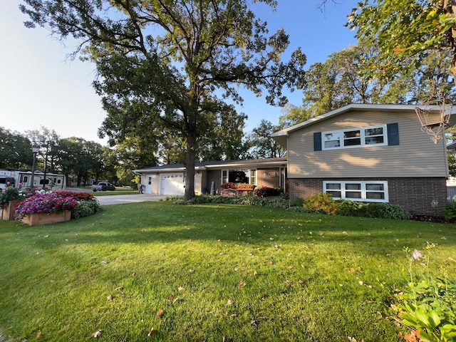 split level home with a front yard and a garage