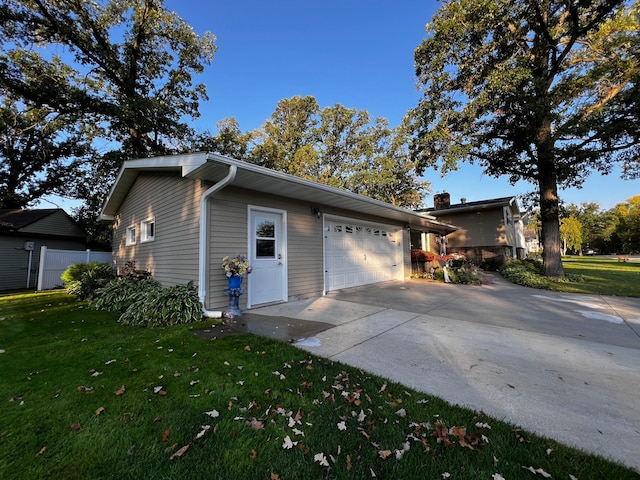 view of property exterior with a yard and a garage