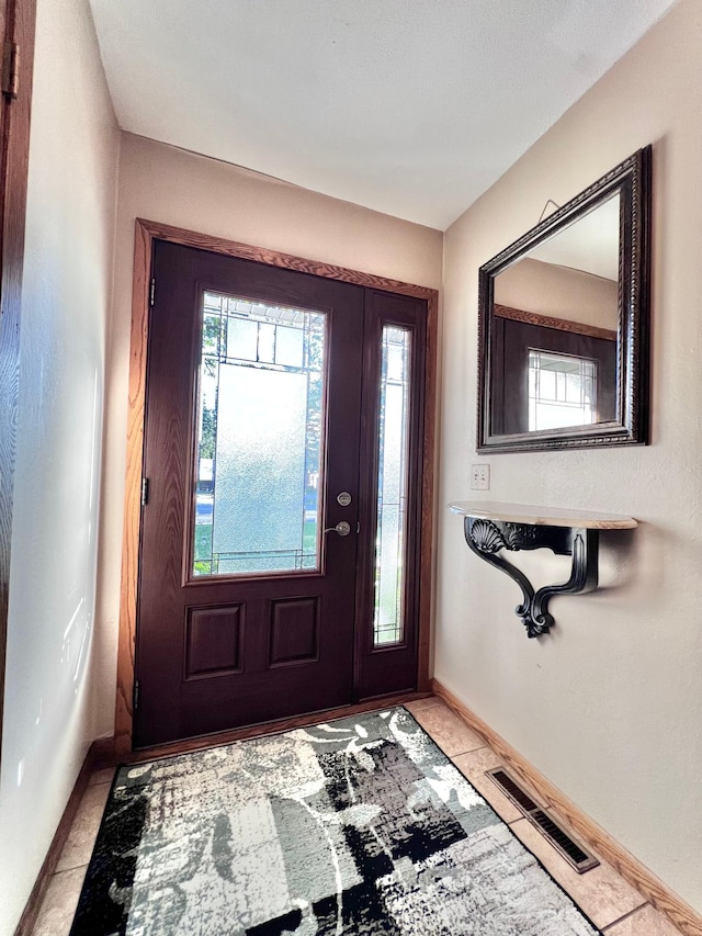 entryway with light tile patterned floors