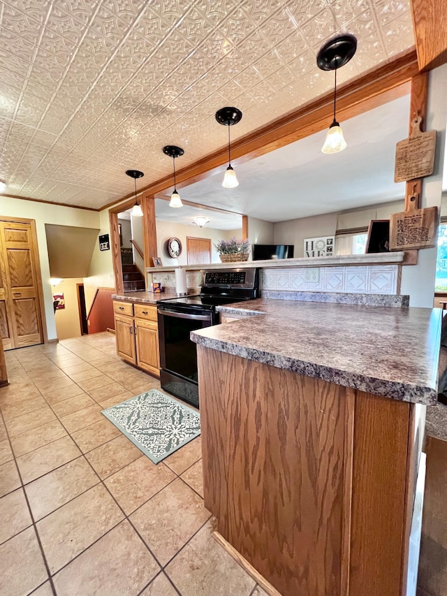 kitchen with decorative light fixtures, crown molding, and black range with electric cooktop