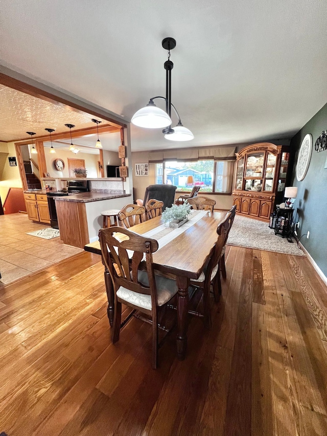 dining area featuring light hardwood / wood-style floors and a textured ceiling