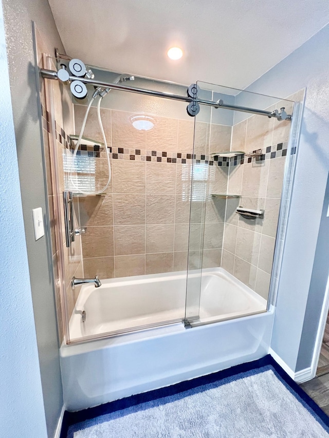 bathroom with shower / bath combination with glass door and hardwood / wood-style floors