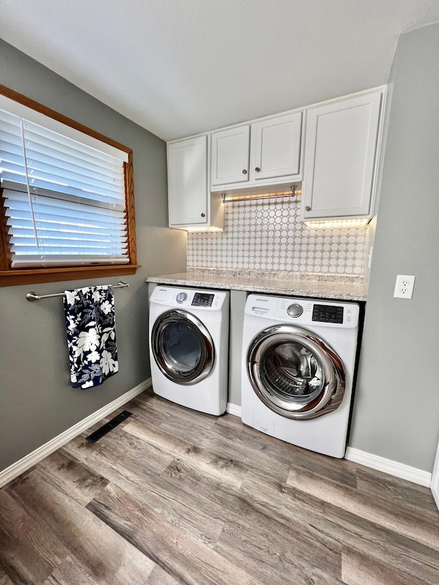 laundry room featuring light wood-type flooring and washing machine and clothes dryer