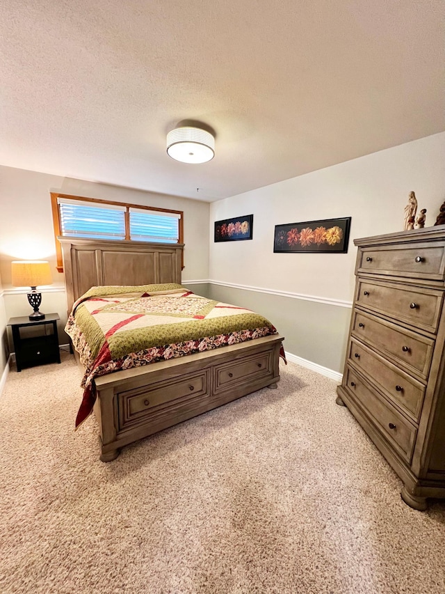 bedroom featuring a textured ceiling and light colored carpet