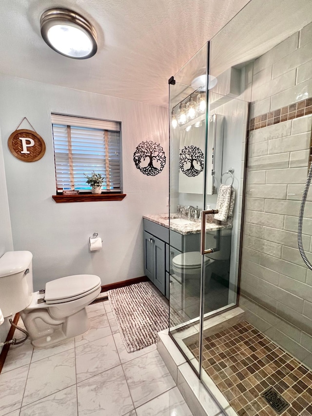 bathroom with a textured ceiling, vanity, an enclosed shower, and toilet