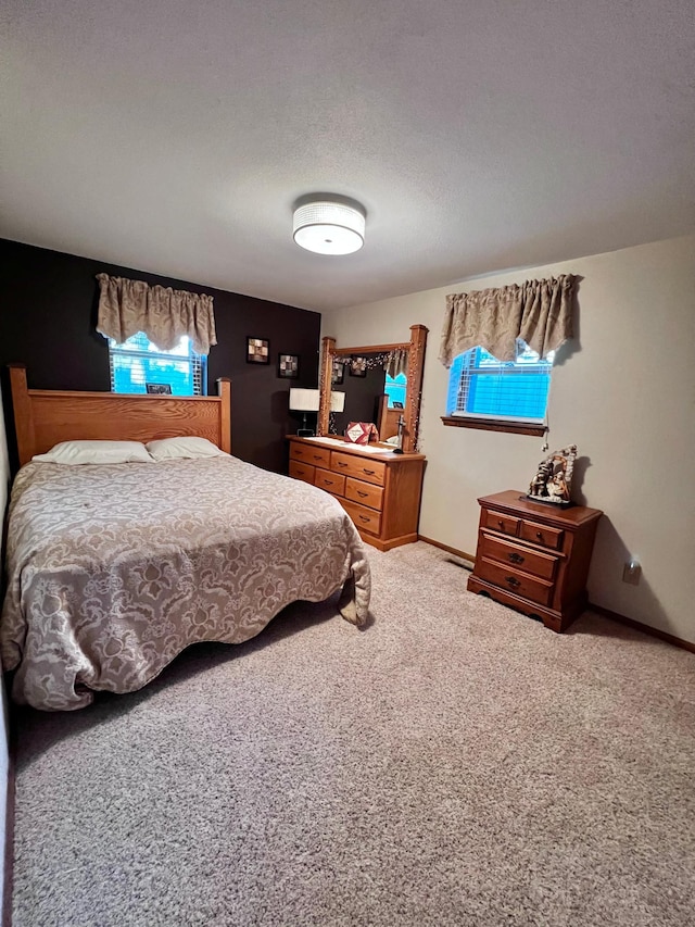 carpeted bedroom featuring a textured ceiling