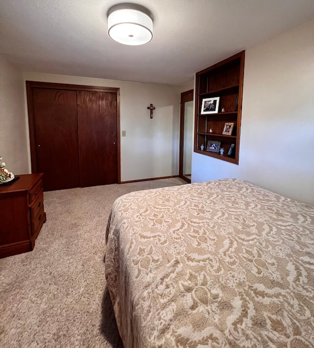 carpeted bedroom featuring a textured ceiling and a closet