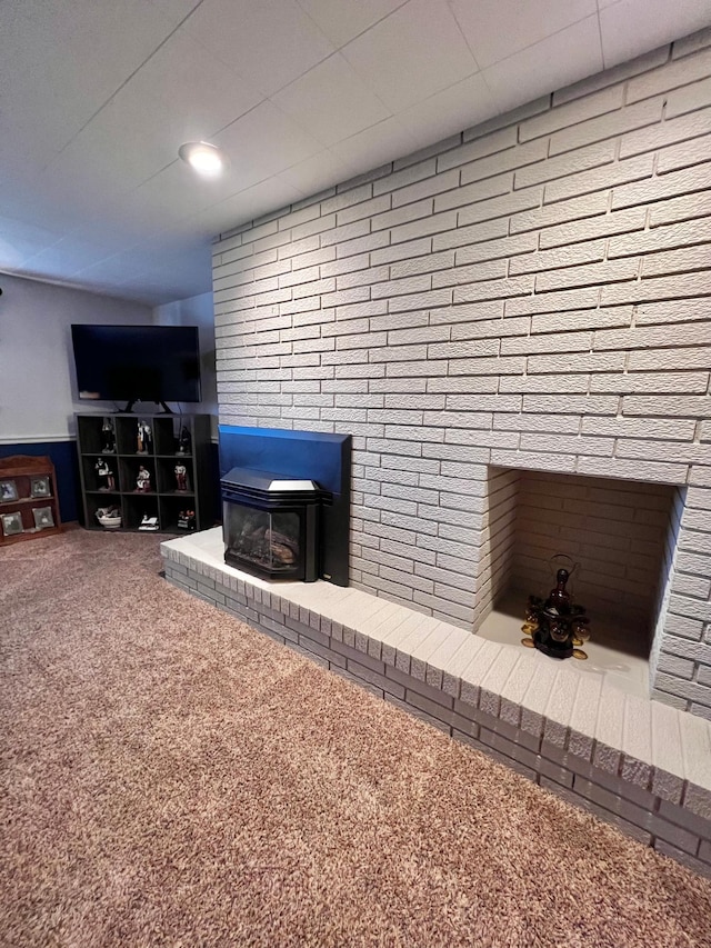 living room featuring carpet and a wood stove