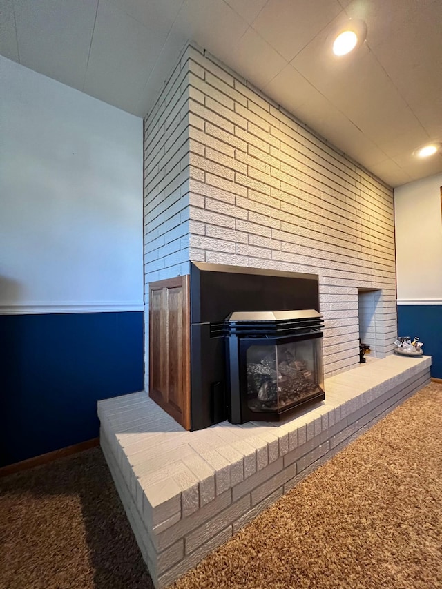 interior details with carpet flooring and a brick fireplace