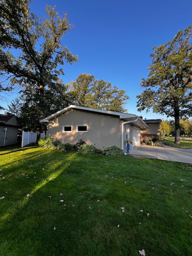 view of side of property with a yard and a garage