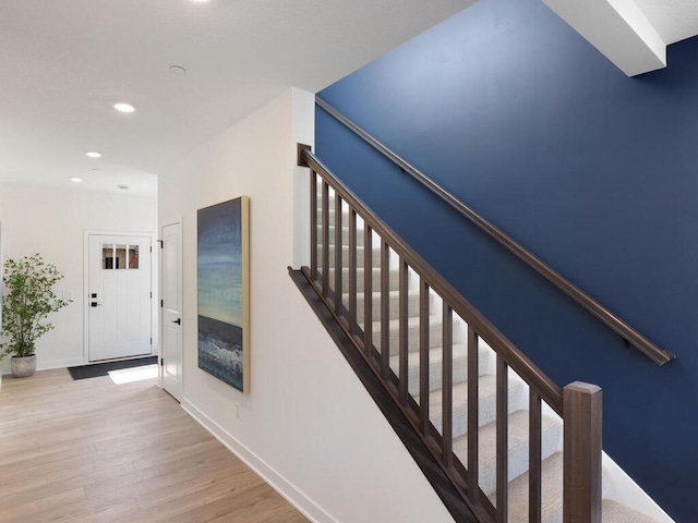 staircase with wood-type flooring