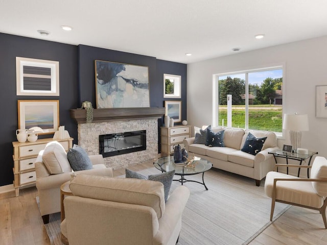 living room featuring light hardwood / wood-style floors and a fireplace