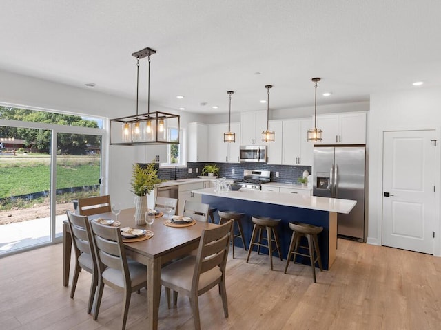 dining room featuring sink and light hardwood / wood-style flooring