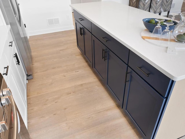 bathroom with vanity and wood-type flooring