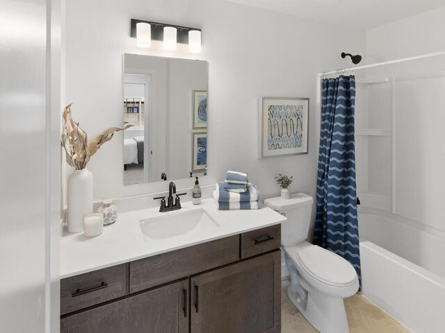 full bathroom with vanity, hardwood / wood-style flooring, toilet, and shower / bathtub combination with curtain