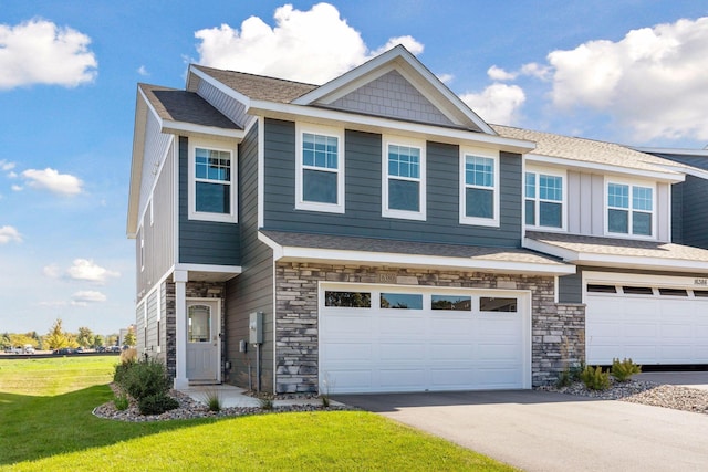 view of front of house featuring a garage and a front lawn