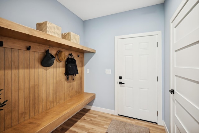 mudroom with light wood finished floors and baseboards