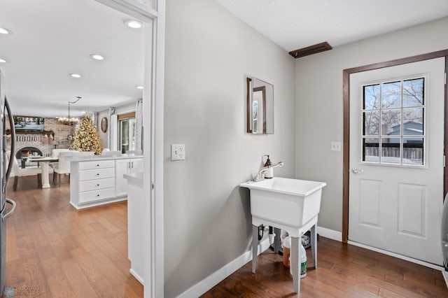 entrance foyer with an inviting chandelier and light hardwood / wood-style flooring